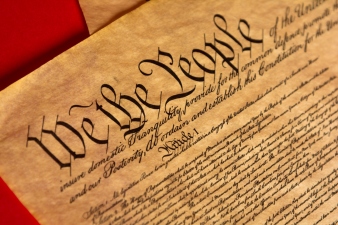 Parchment of the Constitution with a red background