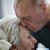 Older man kissing sick wife